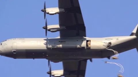Birds eye view of U.S. Army paratroopers exiting side door of C-130 Hercules Stock Footage 103258317