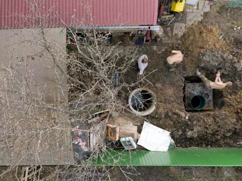 Birds eye view of the workers digging a well Photos