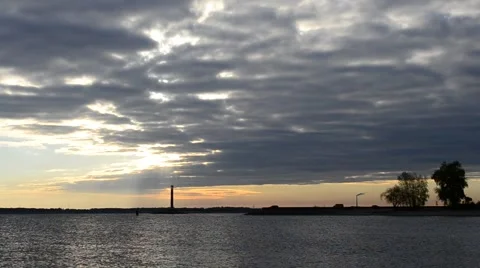 Birds fly on background of lighthouse and dramatic clouds Stock Footage 56738636