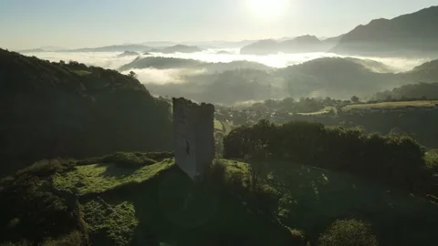 Birds fly in front of the old tower at dawn Stock Footage 166199271