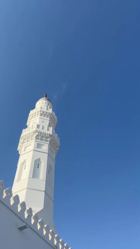 Birds Flying Among Quba Mosque Domes Under Clear Blue Sky of Madinah Stock Footage 310250010