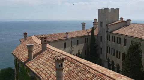 Birds flying over Duino castle rooftops Stock Footage 67382252