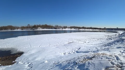 Birds flying over the river and snow on a winter sunny day Stock Footage 87661669