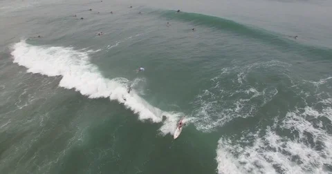 Birdseye aerial follow of surfers on waves Stock Footage