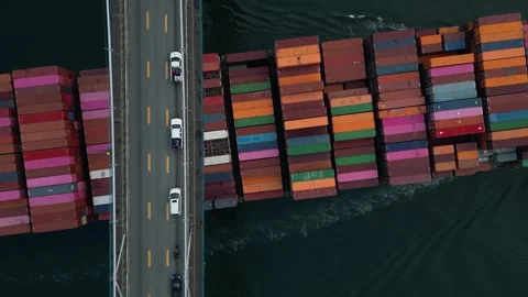Birdseye of container ship passing under Lions Gate bridge in Vancouver 動画素材 248478365