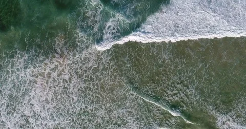 Birdseye drone view of breaking waves on beach Stock Footage 78328328