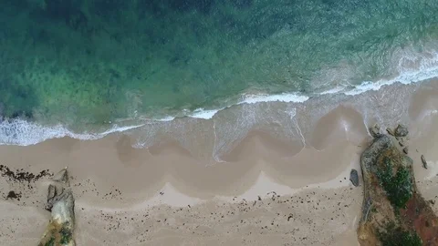 Birdseye drone view left to right or waves and sand Stock Footage 84261605