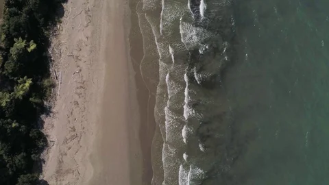 Birdseye to scenery at a perfect calm beach setting Stock Footage