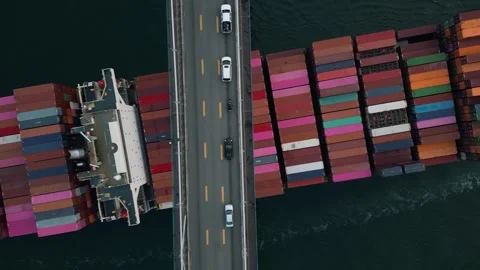 Birdseye of ship passing under bridge 動画素材 248478616