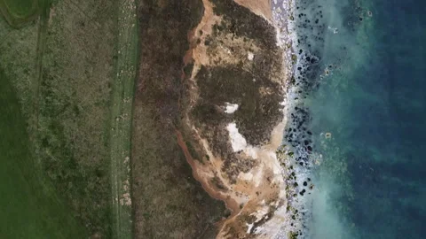 Birdseye View of Cliffs and Sea – HD Drone Reverse Shot Stock Footage 319761272