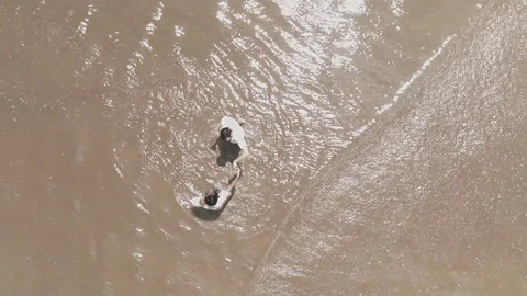 Birdseye View of Couple Dancing in the Shallow Water Beach Video stock 156834259