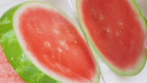 Birdseye View of a Man Cutting a Watermelon into Rings Stock Footage 79049369