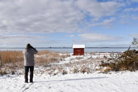 Birdwatcher in a winter landscape Stock Photos