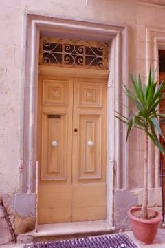 Birgu, ?Malta?: Old fashioned yellow double door from outside with letter box Stock Photos