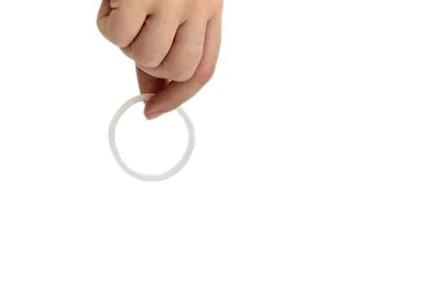 Birth control ,hormone, contraception ring in a womans hand isolated on white Stock Photos
