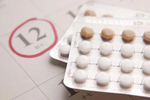 Birth control pills , calendar on table close up Stock Photos
