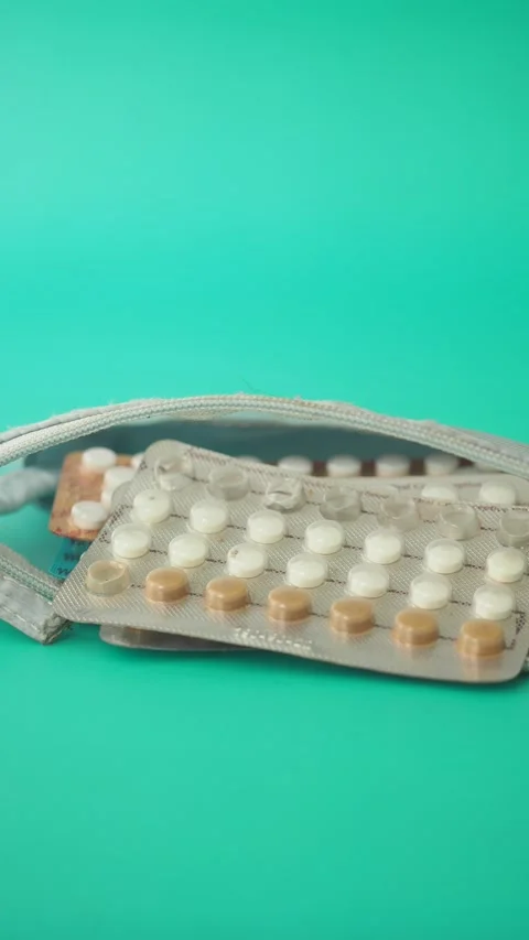 Birth control pills on a green background Stock Footage 326180953
