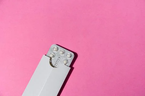 Birth control pills on pink Stock Photos