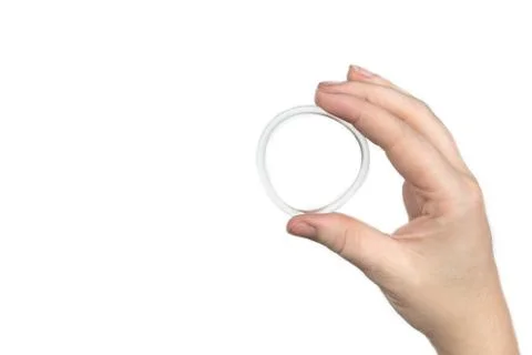 Birth control ring in a womans hand isolated on white background, vaginal ring Stock Photos