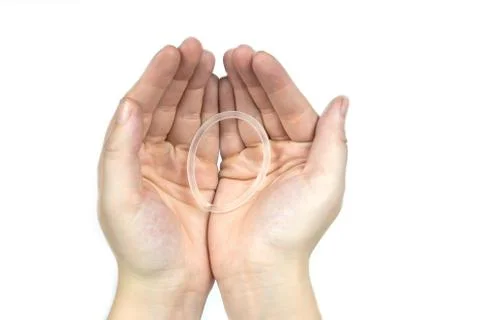 Birth control ring in a womans hand isolated on white background, vaginal ring Stock Photos