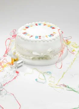 Birthdat cake and streamers Stock Photos