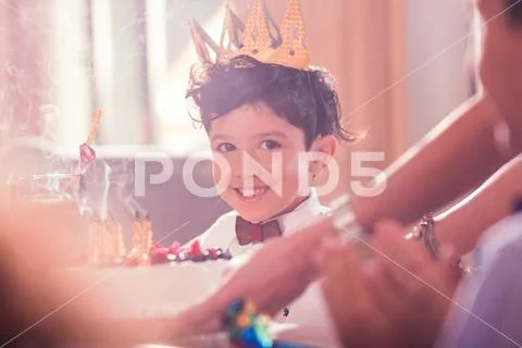 Birthday boy feeling satisfied after blowing candles on the cake Stock Photos