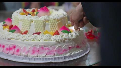 Birthday cake being cut with hands visible, no face visible Stock Footage 329774504
