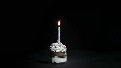 Birthday Cake with a candle on a black b... | Stock Video | Pond5