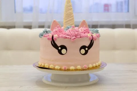 Birthday cake in the form of a multi colored unicorn. Sweet cute cake Stock Photos