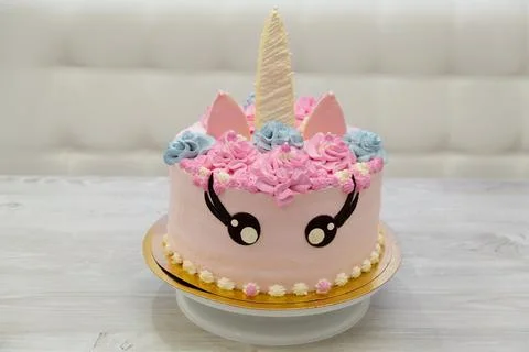 Birthday cake in the form of a multi colored unicorn. Sweet cute cake Stock Photos