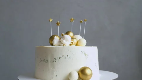 Birthday cake with golden decorative elements rotates on gray background Stock Footage 152709144