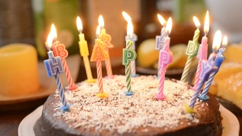 A birthday cake with lighted candles Stock Footage 106515457