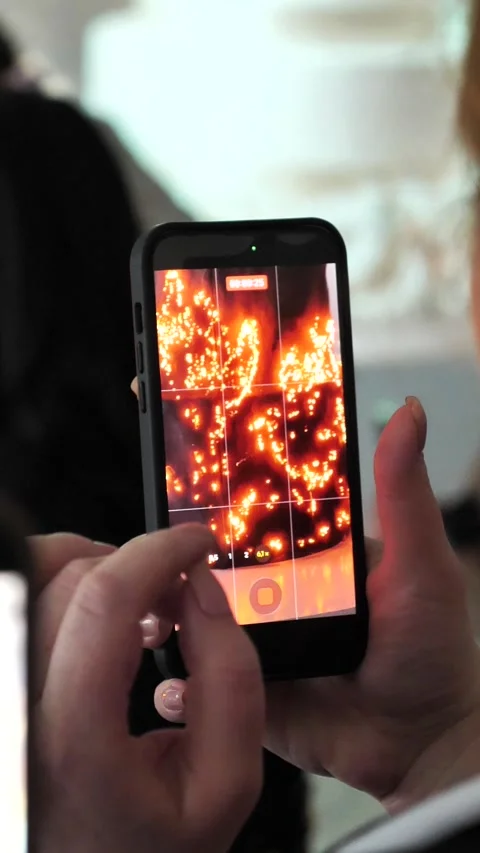 A birthday cake is set on fire and filmed on a phone camera. Stock Footage 337580602