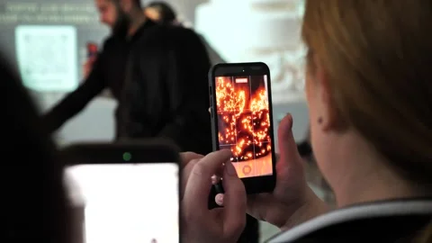 A birthday cake is set on fire and filmed on a phone camera. Stock Footage 337580604