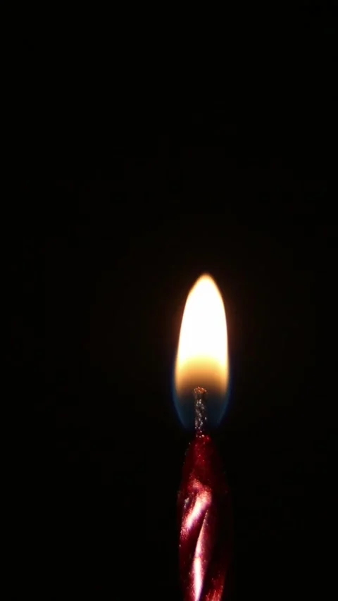 Birthday candle igniting and burning brightly on dark background Stock Footage 339568188