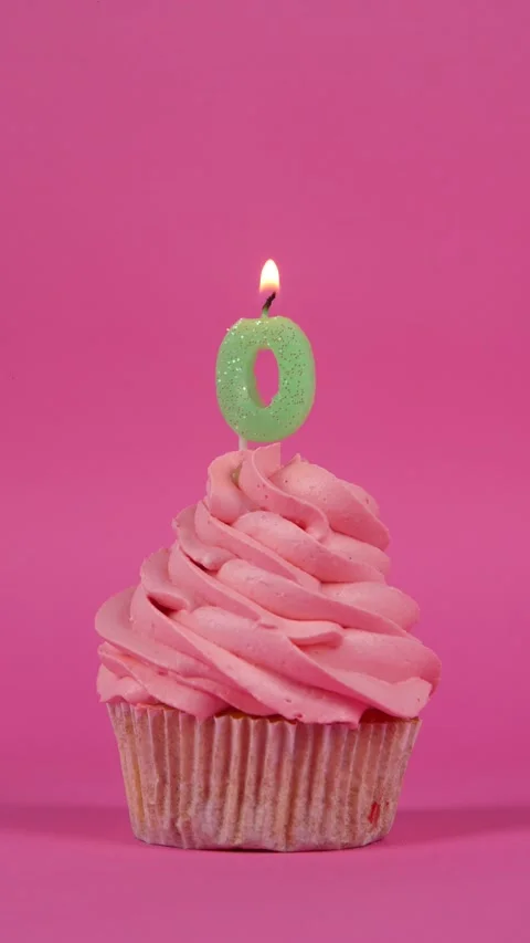 Birthday cupcake with number zero candle on a pink background. Holiday concept Stock Footage 275145437