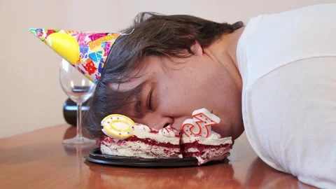 Birthday man got drunk on wine, sleeps face in plate with cake midlife crisis Stock Footage 278435301