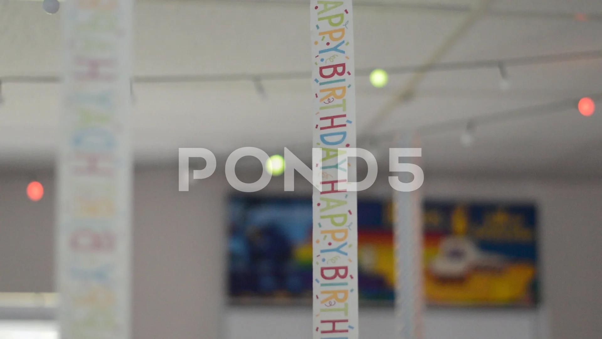 Birthday Streamers Hanging From Ceiling In An Apartment Shot In