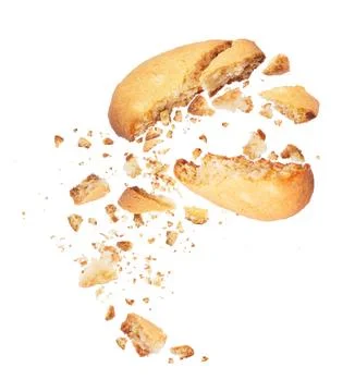 Biscuit broken into two halves with falling crumbs down Stock Photos