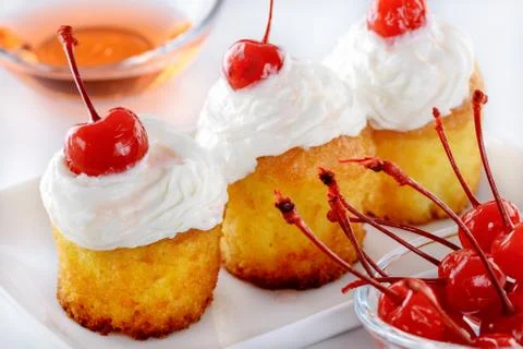Biscuit cakes with cocktail cherry Stock Photos