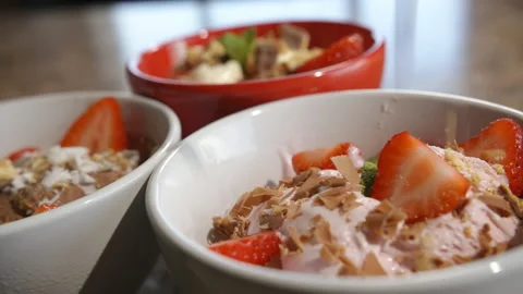 Biscuit/ Cookie crumbs falling onto ice cream as camera pans around Stock Footage 162670773