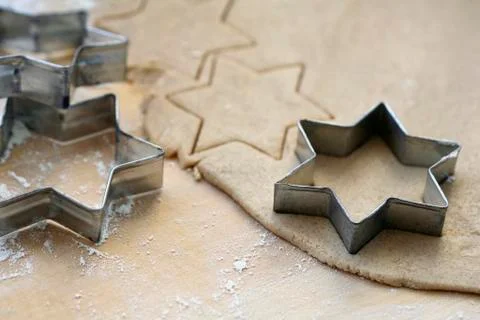 Biscuit dough with star-shaped cutters Stock Photos