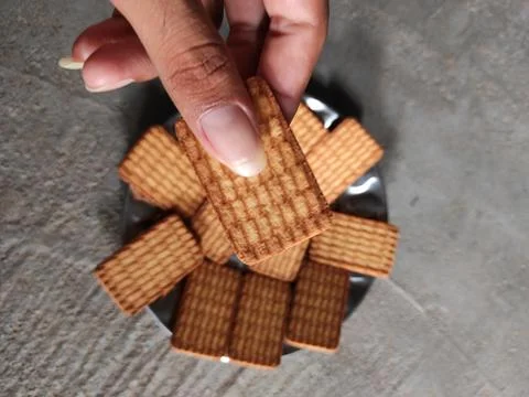 Biscuit held in hand Stock Photos
