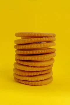 Biscuit on yellow background, Closeup cracker on vintage background, Round co Stock Photos