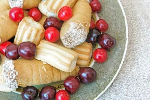 Biscuits and cherries on the plate. The view from the top Stock Photos