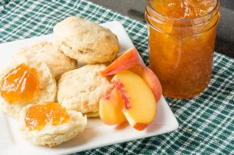 Biscuits and fresh peach jam Stock Photos