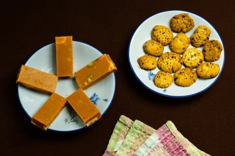 Biscuits and sweet barfi on a table Stock Photos