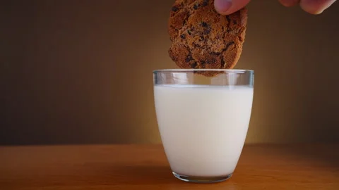 The biscuits are dipped in milk. Video stock 255243829