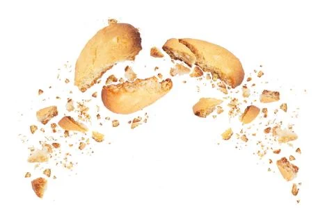 Biscuits broken into two halves with falling crumbs down, isolated on white.. Stock Photos