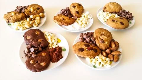 Biscuits with chocolate chips and almonds, hazelnuts or cocoa powder Stock Photos